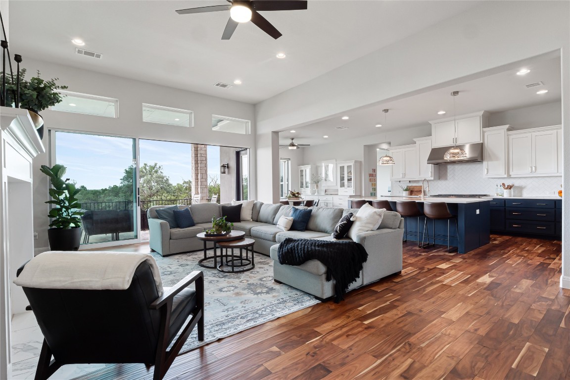 504 Loyal June Trail Leander, TX 78641 - Photo 2 of 16 a living room with furniture wooden floor and a kitchen view