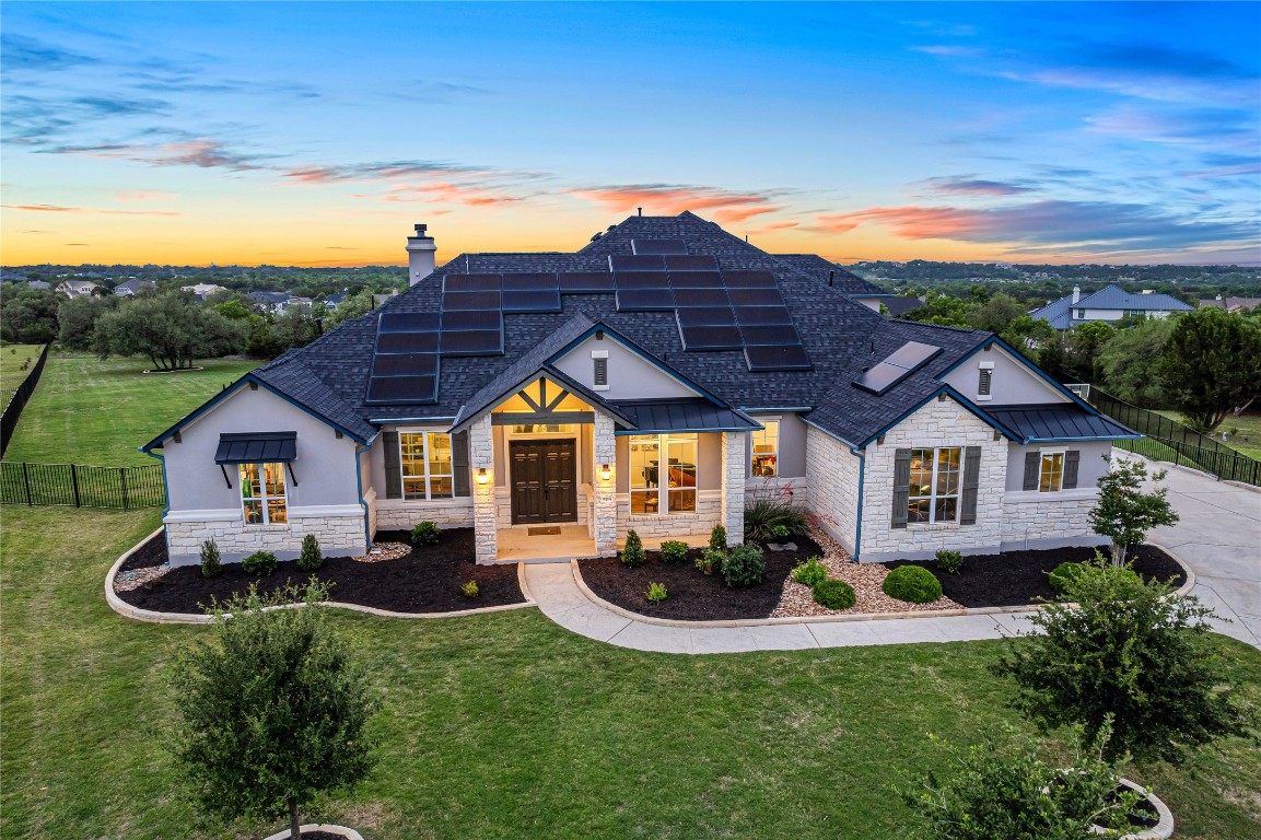 504 Loyal June Trail Leander, TX 78641 - Photo 4 of 16 a view of a house with table and chairs under an umbrella