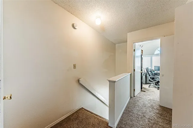 a en suite bathroom with a granite countertop sink and a mirror