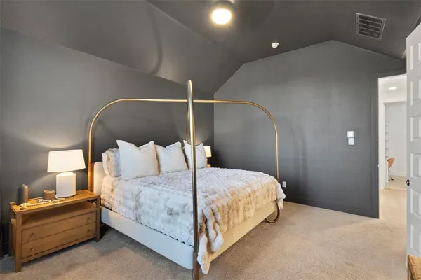 a bedroom with a bed and a mirror