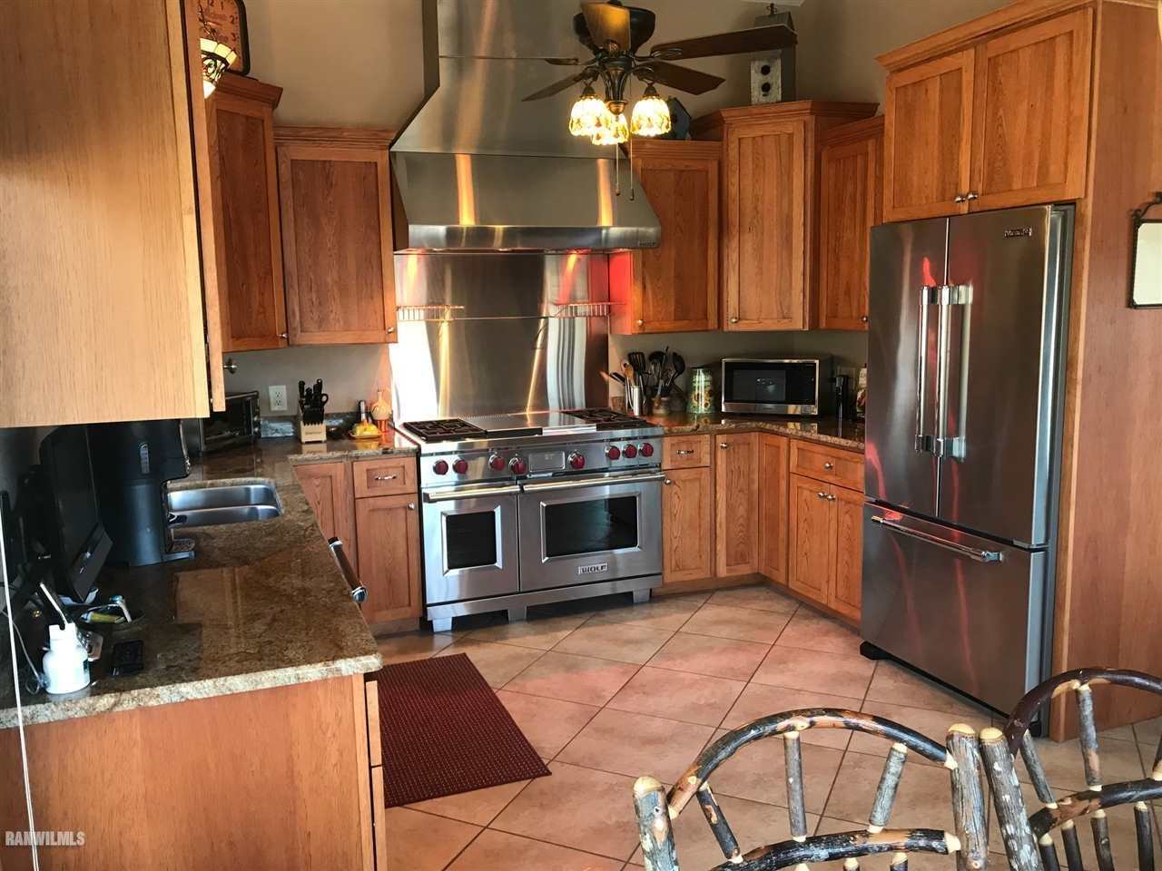 9034 South Gamble Hill Road Elizabeth, IL 61028 - Photo 3 of 24 a kitchen with a refrigerator a stove and a sink