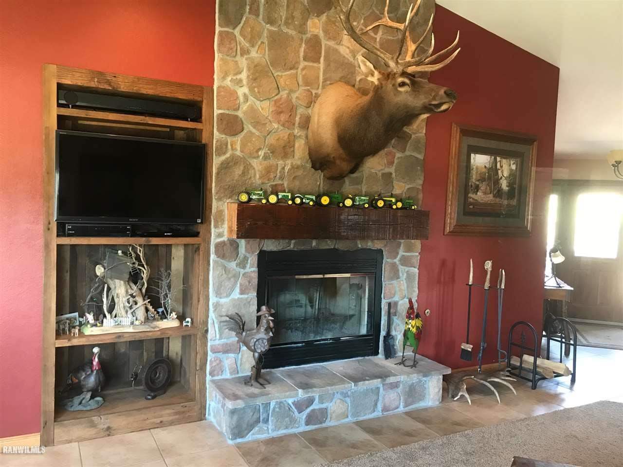 9034 South Gamble Hill Road Elizabeth, IL 61028 - Photo 5 of 24 a fireplace with wooden frame