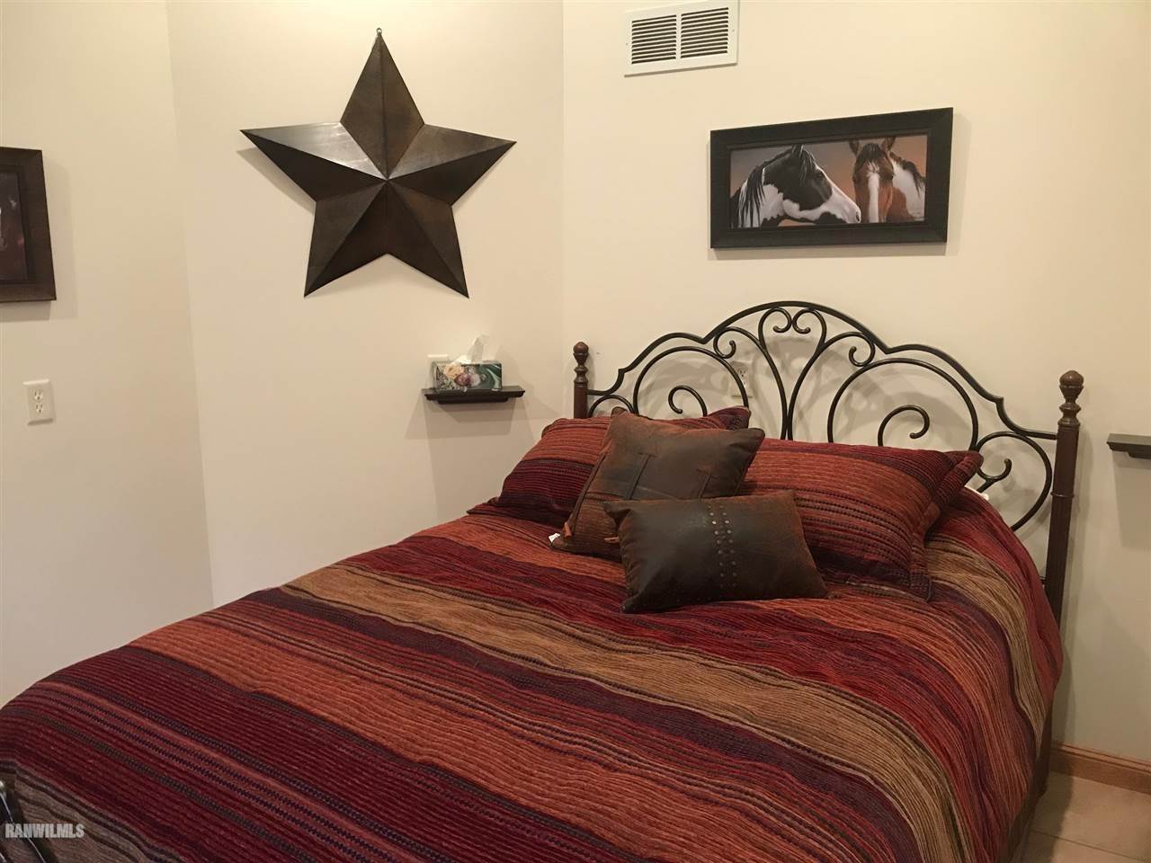 9034 South Gamble Hill Road Elizabeth, IL 61028 - Photo 10 of 24 a bedroom with a bed and a painting on the wall