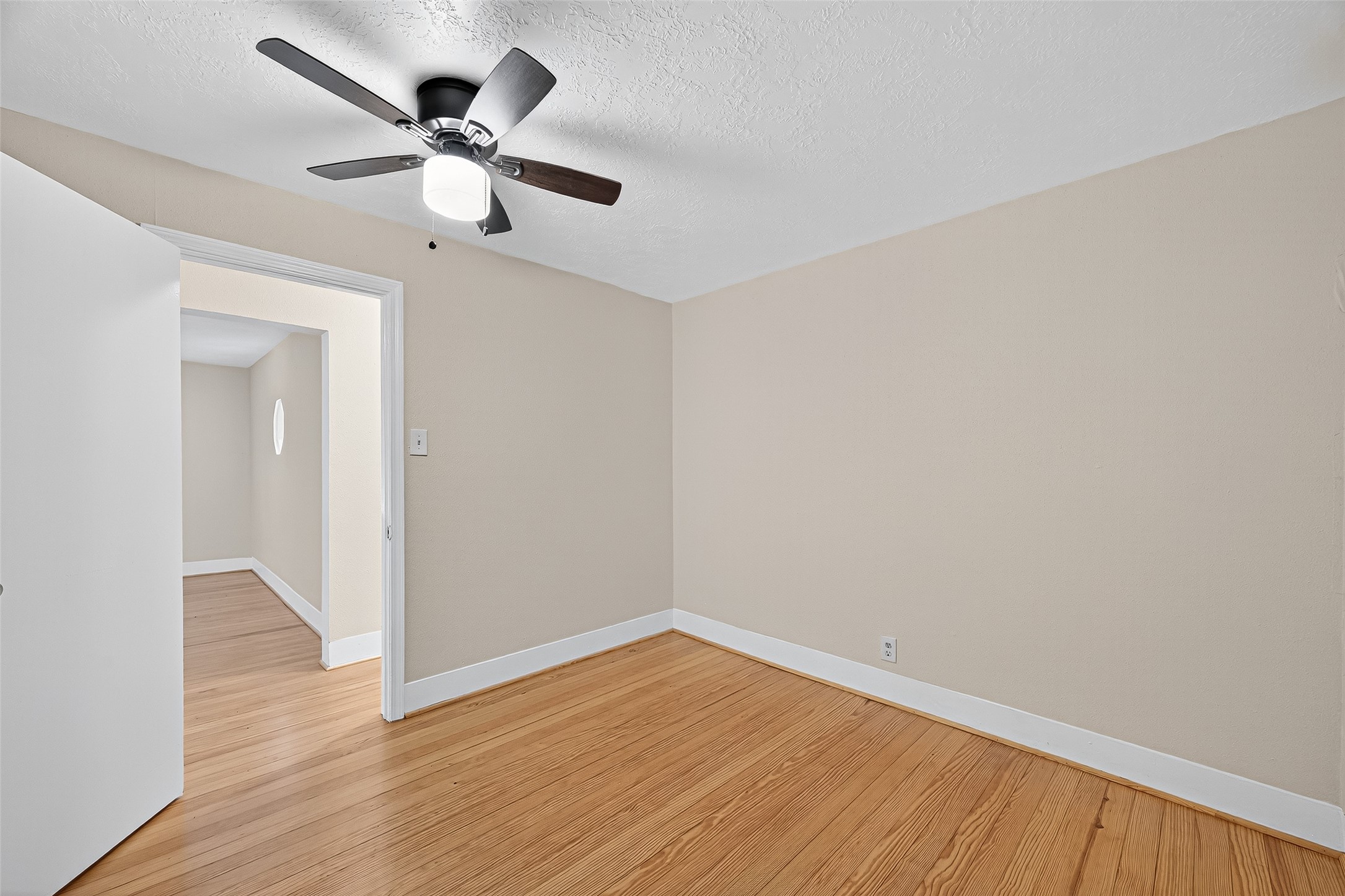 5122 Larkin Street Houston, TX 77007 - Photo 21 of 28 Recent ceiling fan light fixture and those super nice, refinished wood floors.