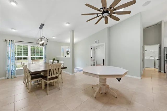 a living room with furniture and a view of kitchen