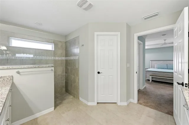 a living room with furniture and a ceiling fan