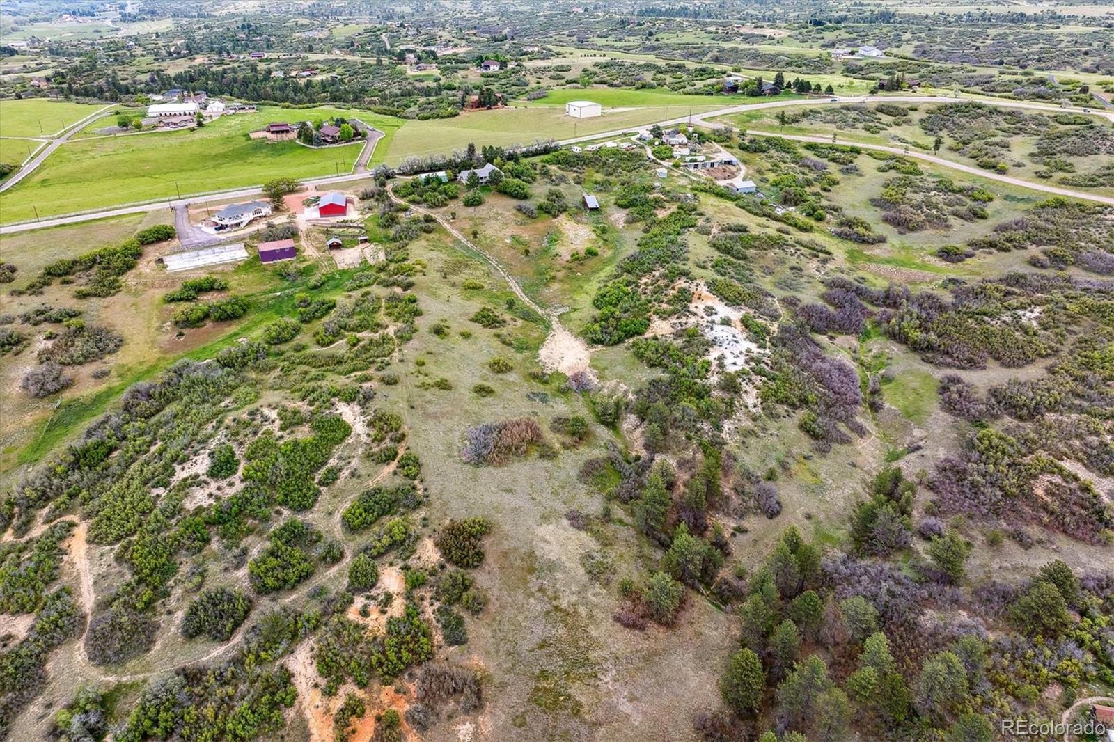 2938 West Wolfensberger Road Sedalia, CO 80135 - Photo 13 of 50 a view of a city with mountains in the background
