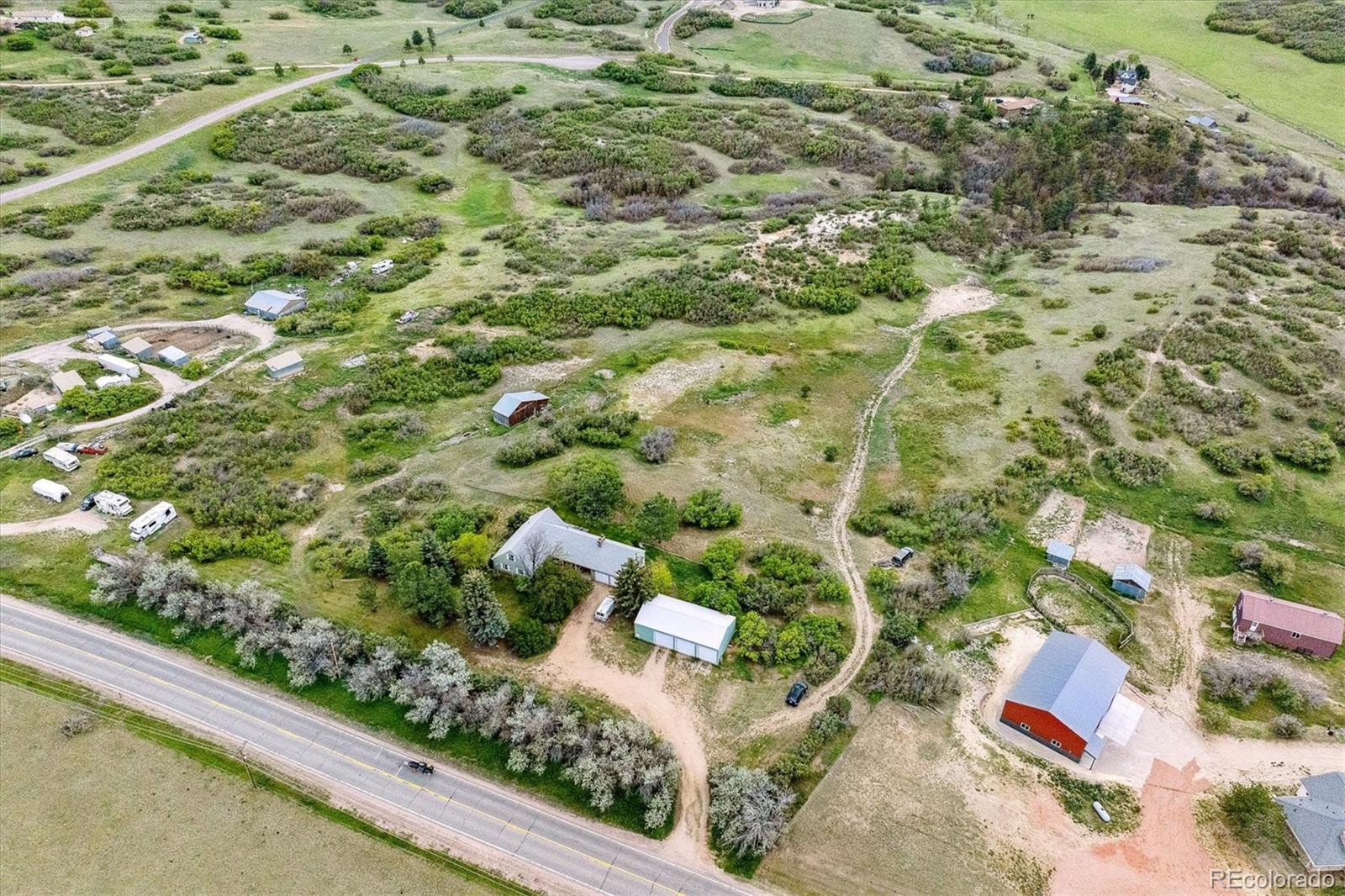 2938 West Wolfensberger Road Sedalia, CO 80135 - Photo 16 of 50 a view of a garden with plants