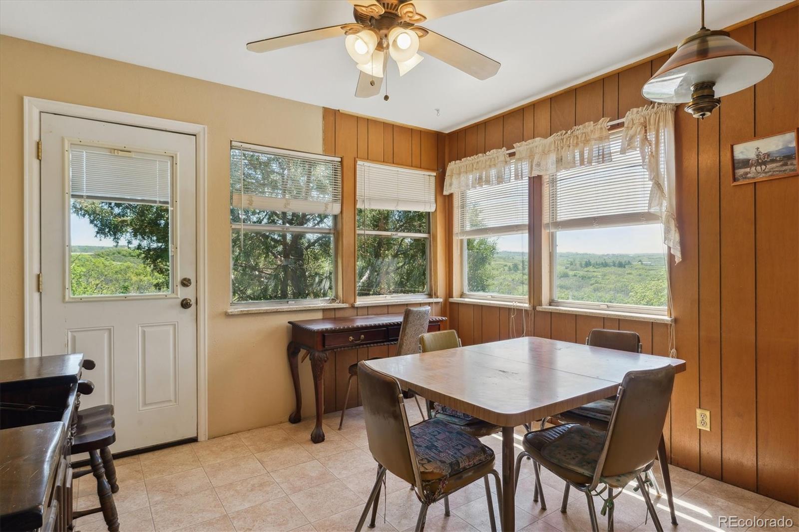 2938 West Wolfensberger Road Sedalia, CO 80135 - Photo 26 of 50 a view of a dining room with furniture window and outside view