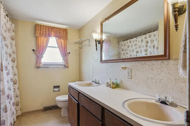 a bedroom with bed and a chandelier