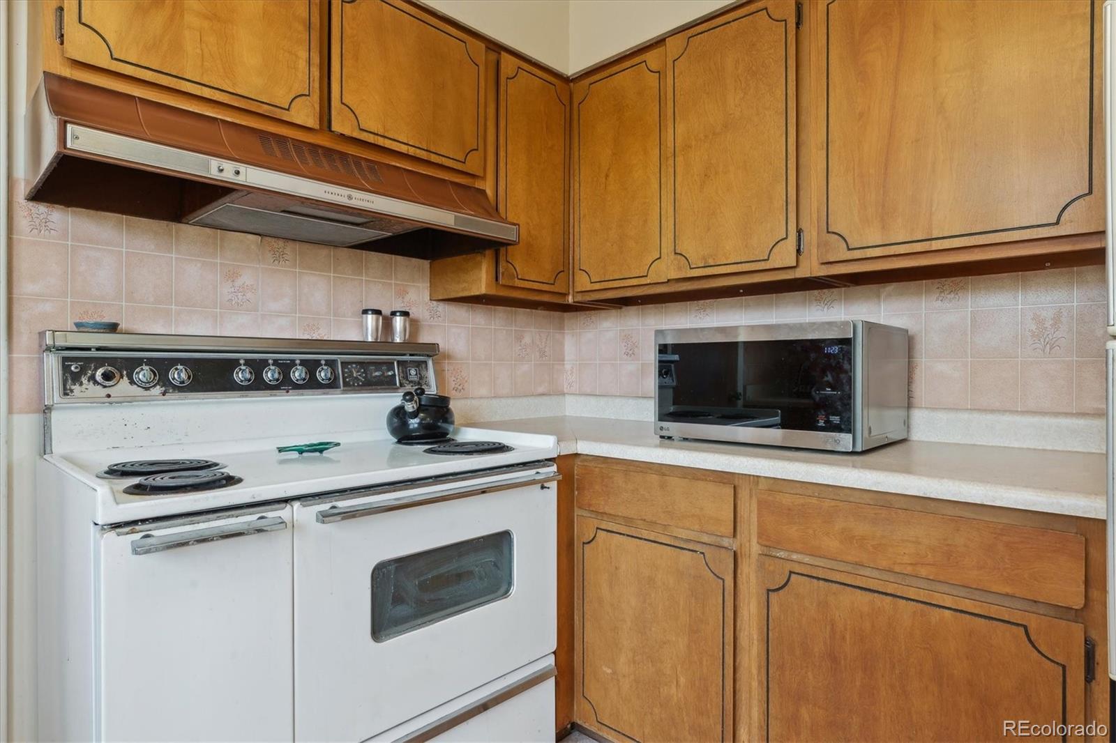 2938 West Wolfensberger Road Sedalia, CO 80135 - Photo 28 of 50 a kitchen with stainless steel appliances granite countertop a sink a stove and microwave