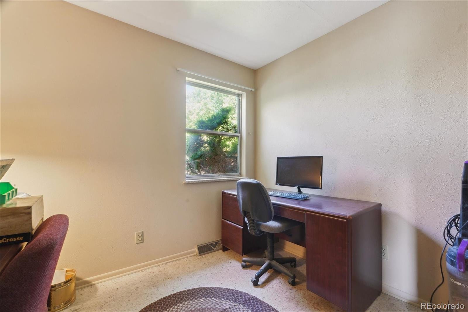 2938 West Wolfensberger Road Sedalia, CO 80135 - Photo 29 of 50 a view of a workspace with furniture and a window