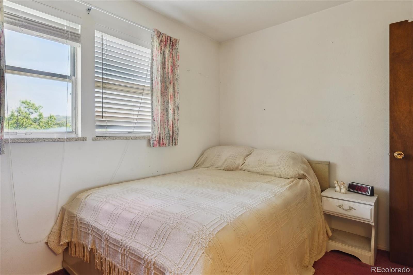 2938 West Wolfensberger Road Sedalia, CO 80135 - Photo 31 of 50 a bedroom with a bed and a window