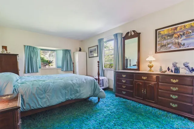 a room with furniture pool table and window