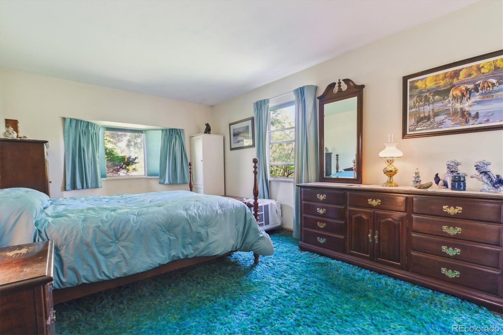 2938 West Wolfensberger Road Sedalia, CO 80135 - Photo 33 of 50 a spacious bedroom with a bed dresser and a window