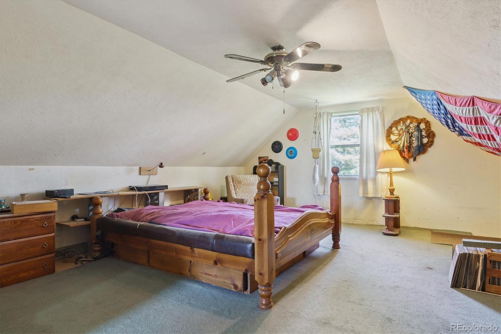 2938 West Wolfensberger Road Sedalia, CO 80135 - Photo 35 of 50 a bedroom with bed and a chandelier