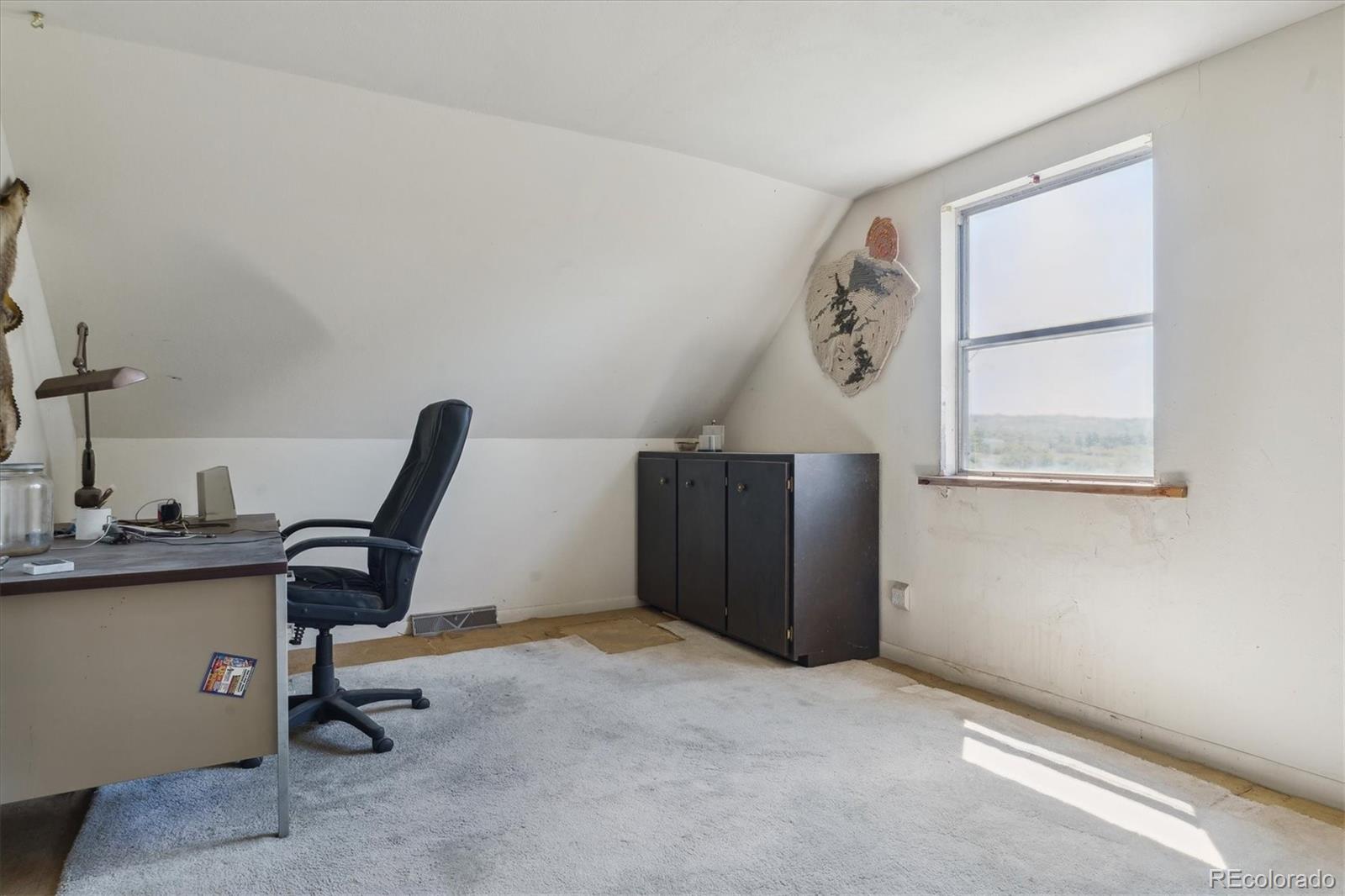 2938 West Wolfensberger Road Sedalia, CO 80135 - Photo 37 of 50 a view of a workspace with furniture