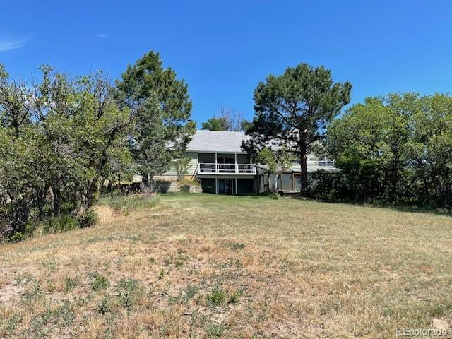 2938 West Wolfensberger Road Sedalia, CO 80135 - Photo 5 of 50 a front view of a house with a yard