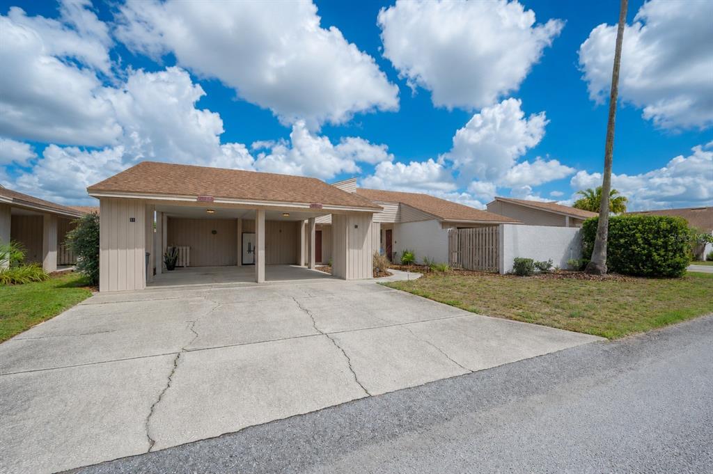 4231 Oak Loop, Unit 51 Mulberry, FL 33860 - Photo 2 of 29 a front view of a house with a garden and trees