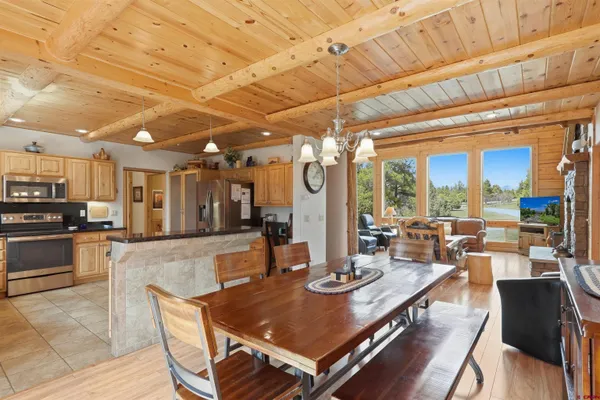 a view of a dining room with furniture wooden floor and chandelier