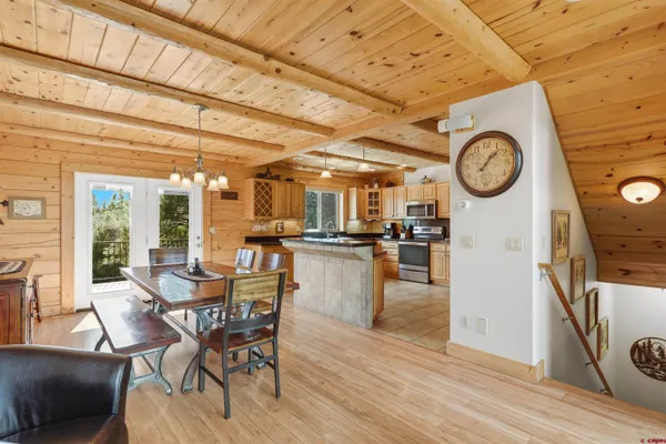 a view of a room with furniture and kitchen view