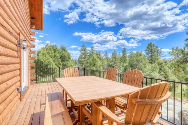 a view of a patio with table and chairs with wooden floor