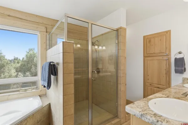 a bathroom with a granite countertop shower mirror and a sink