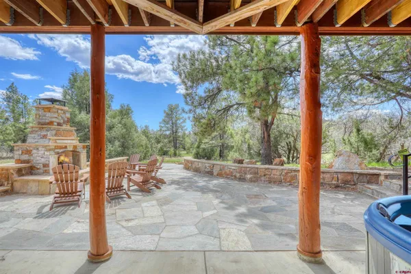 a view of a patio with a table and chairs next to a yard