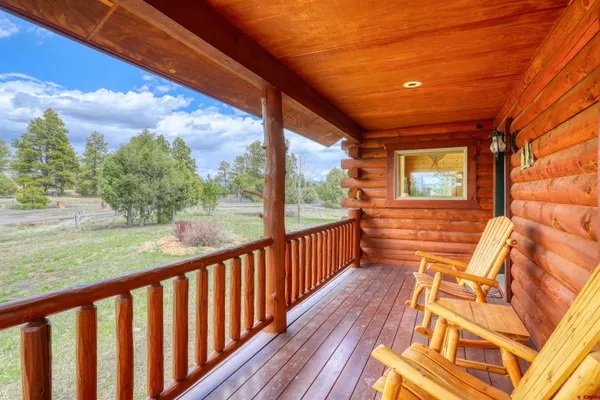 a view of a porch with wooden floor and outdoor space