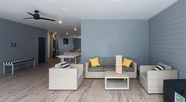 a living room with furniture and wooden floor