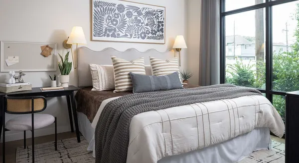 a bedroom with a bed and a window