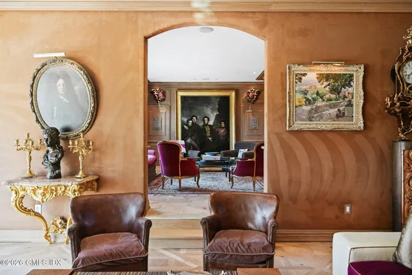 a living room with furniture a large window and a dining table
