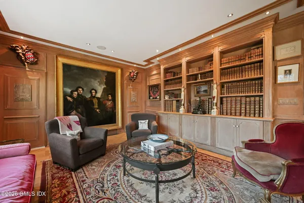 a living room with furniture or couch and a kitchen view