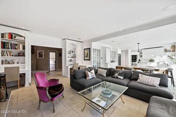 a bathroom with a tub a sink and a large mirror