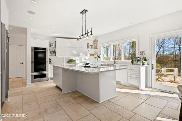 a bedroom with a bed and a large window with the outer view