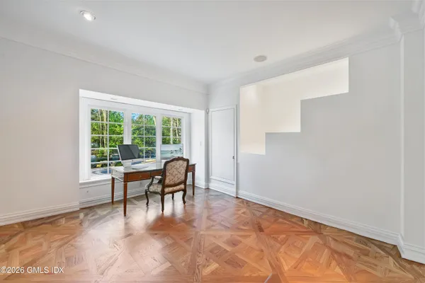 a living room with furniture and painting on the wall