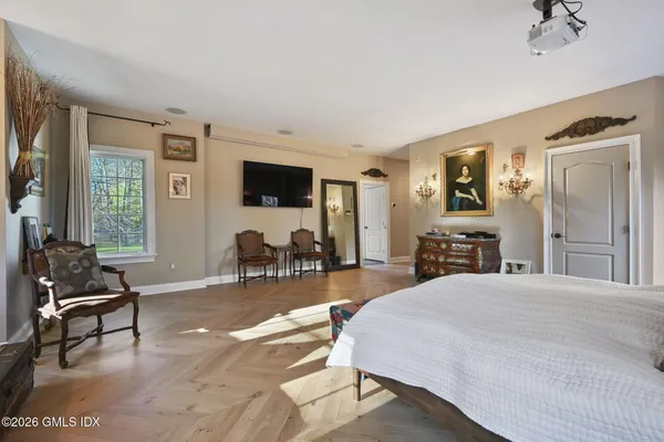 a bedroom with a large bed and a large window