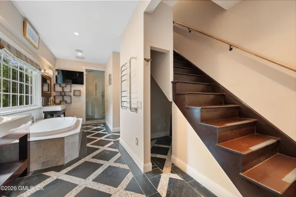 a bathroom with a granite countertop sink mirror and bathtub