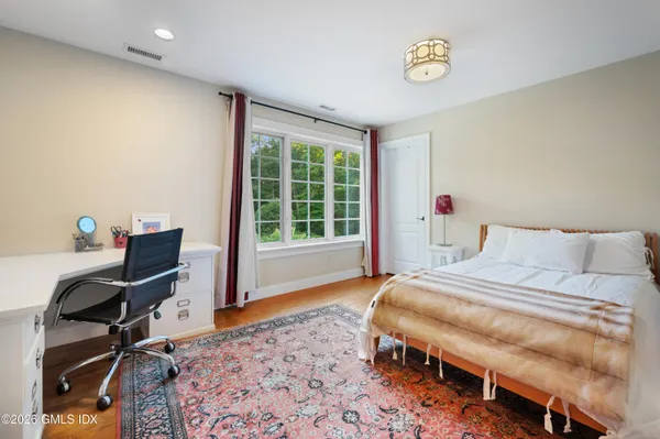 a front view of a house with yard and green space