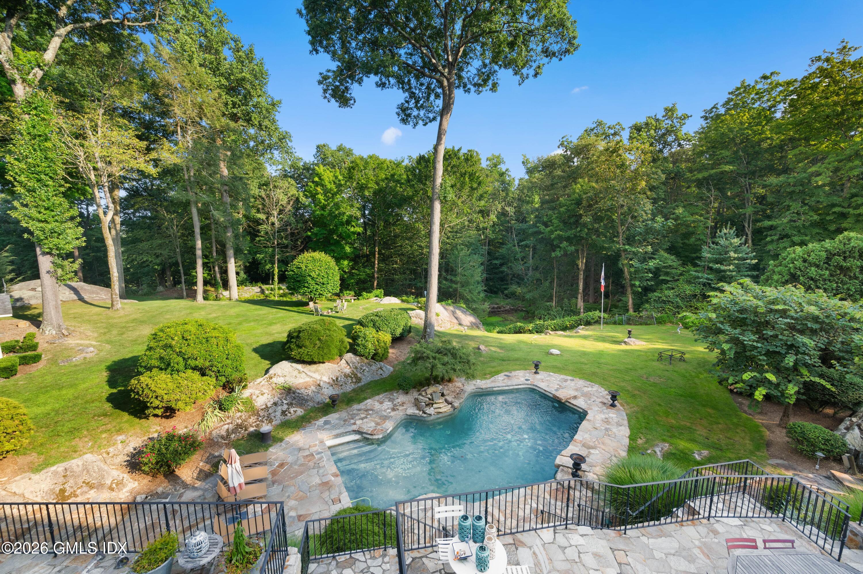 367 Riversville Road Greenwich, CT 06831 - Photo 54 of 66 a view of a garden with a fountain