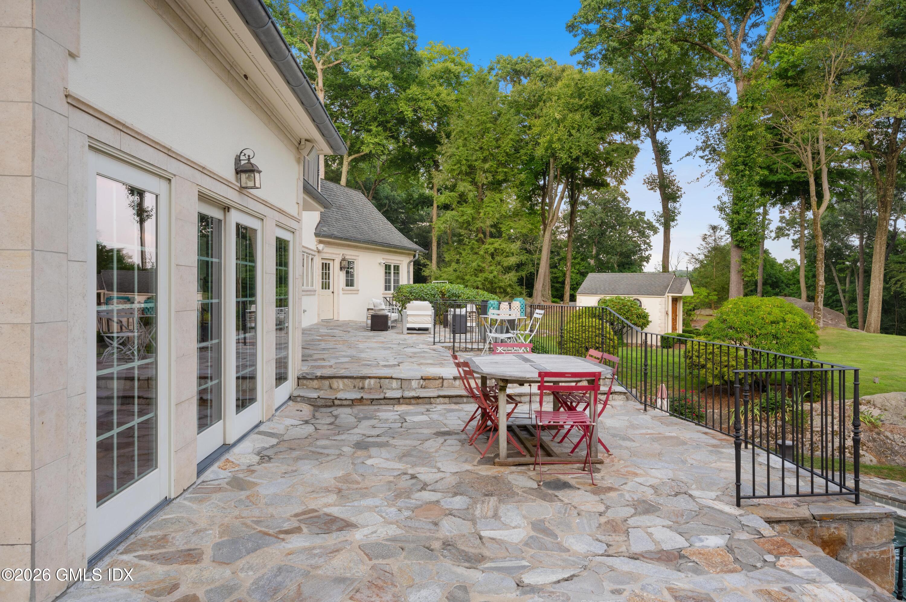 367 Riversville Road Greenwich, CT 06831 - Photo 56 of 66 a view of a patio with a table and chairs and potted plants