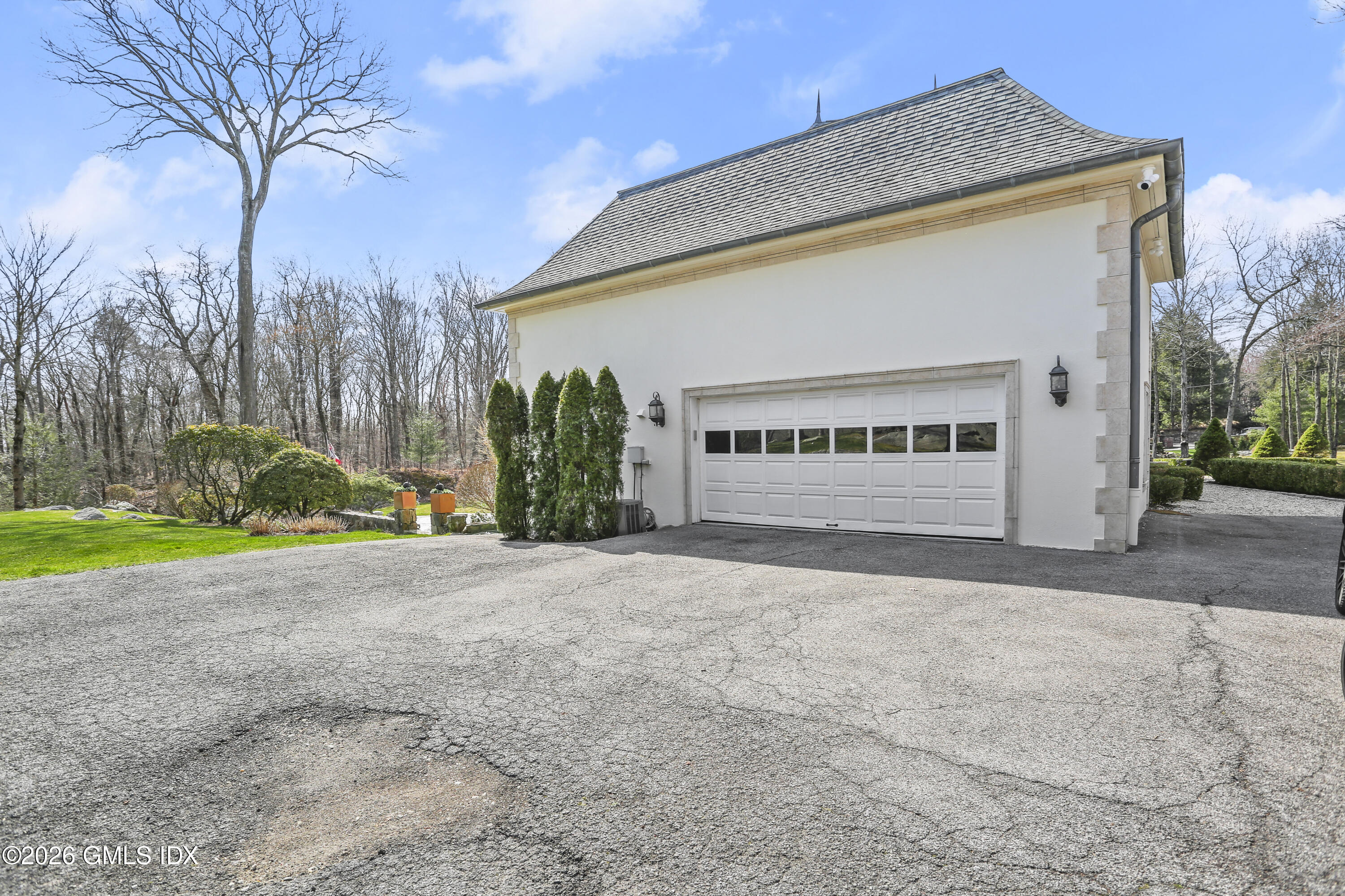 367 Riversville Road Greenwich, CT 06831 - Photo 60 of 66 a view of a house with a yard and garage