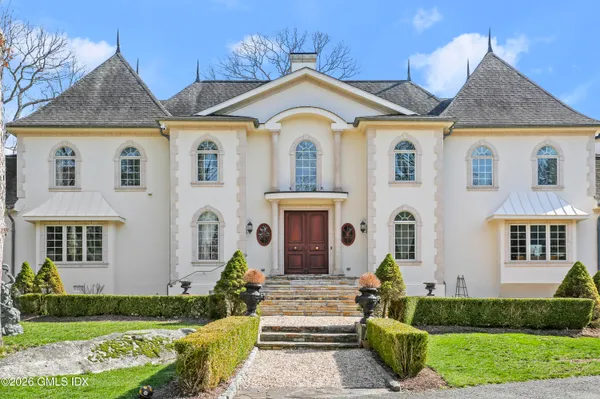 a living room with furniture and a mirror