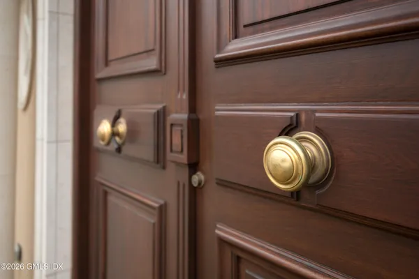 a living room with furniture and a mirror