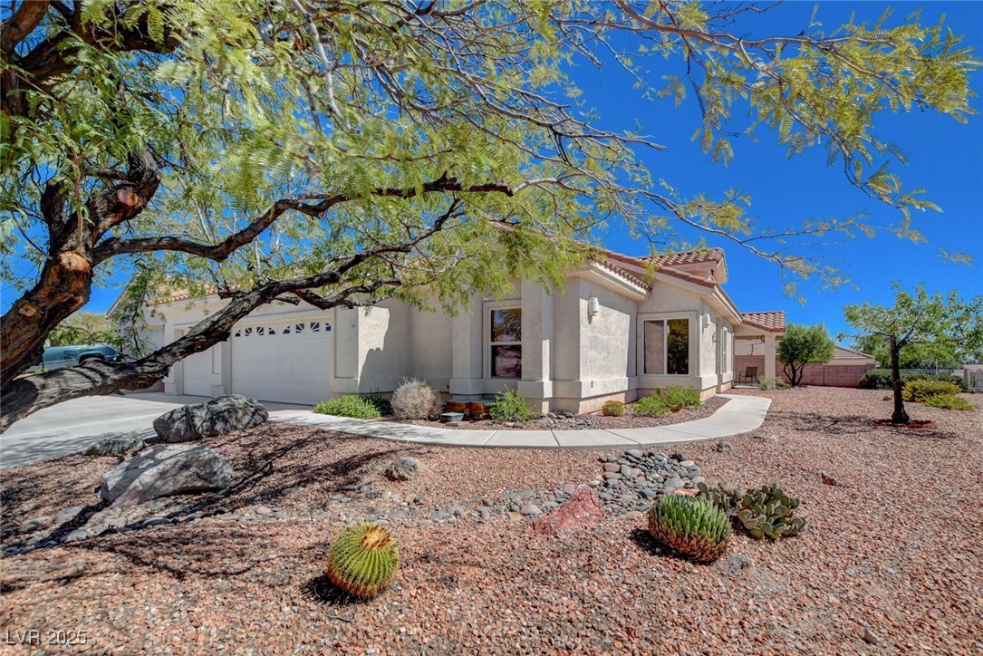 1104 Endora Way Boulder City, NV 89005 - Photo 2 of 36 View of front of home with stucco siding, concrete driveway, a tiled roof, and an attached garage