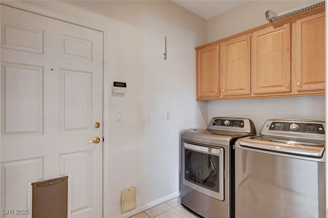 1104 Endora Way Boulder City, NV 89005 - Photo 20 of 36 Laundry room featuring light tile patterned flooring, independent washer and dryer, and cabinet space
