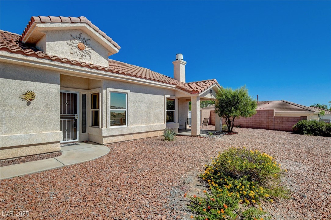 1104 Endora Way Boulder City, NV 89005 - Photo 31 of 36 Back of house featuring a chimney, stucco siding, and a tile roof