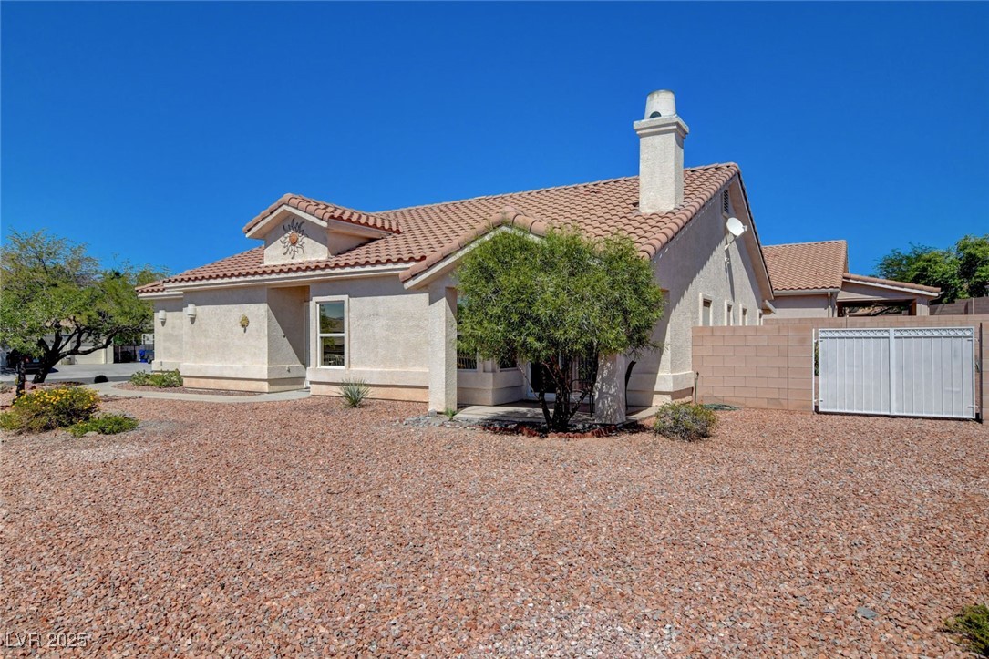 1104 Endora Way Boulder City, NV 89005 - Photo 32 of 36 Rear view of property with stucco siding and a tile roof