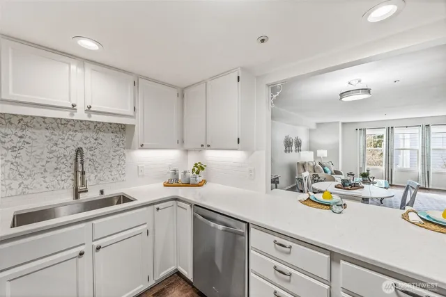 a kitchen with a sink appliances and cabinets