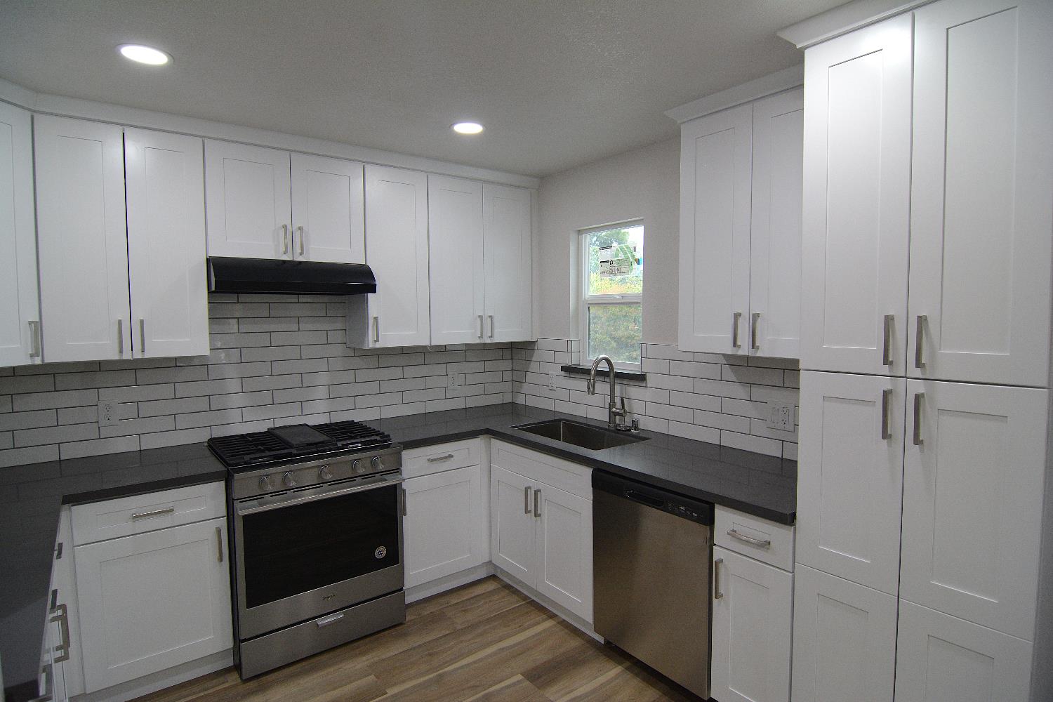 7536 Cosgrove Way Sacramento, CA 95822 - Photo 11 of 22 a kitchen with a sink and white cabinets